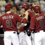 Arizona Diamondbacks' Paul Goldschmidt, center, is greeted by teammates A.J. Pollock (11) and Gerardo Parra (8) after hitting a three run home run against the Chicago Cubs during the sixth inning of a baseball game, Wednesday, July 24, 2013, in Phoenix. (AP Photo/Matt York)