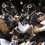 Chicago Bears quarterback Josh McCown (12) celebrate a touchdown run with defensive tackle Corey Wootton (98) during the first half of an NFL football game against the Dallas Cowboys, Monday, Dec. 9, 2013, in Chicago. (AP Photo/Nam Y. Huh)