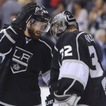 Los Angeles Kings center Jarret Stoll (28) congratulates goalie Jonathan Quick (32) after the Kings defeated the Chicago Blackhawks 3-1 in Game 3 of the NHL hockey Stanley Cup playoffs Western Conference finals, Tuesday, June 4, 2013, in Los Angeles. (AP Photo/Mark J. Terrill)