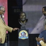 Curley Culp smiles as he looks at his bust after his son, Chad unveiled it during the induction ceremony at the Pro Football Hall of Fame Saturday, Aug. 3, 2013, in Canton, Ohio. (AP Photo/Tony Dejak)
