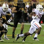 Arizona's Ka'Deem Carey (25) gets past Arizona State's Clint Floyd, left, and Corey Adams, back middle, during the second quarter of an NCAA college football game Saturday, Nov. 19, 2011, in Tempe, Ariz. (AP Photo/Ross D. Franklin)