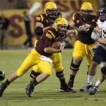  Arizona State quarterback Taylor Kelly, left, runs for a first down against the Northern Arizona defense during the first half of their NCAA college football game on Thursday, Aug. 30, 2012, in Tempe, Ariz. (AP Photo/Rick Scuteri)