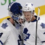 Toronto Maple Leafs goalie James Reimer (34) celebrates with teammate Carl Gunnarsson (36), from Sweden, after defeating the Montreal Canadiens 4-3 during an NHL hockey season opener on Tuesday, Oct. 1, 2013, in Montreal. (AP Photo/The Canadian Press, Ryan Remiorz)

