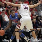 Florida's Michael Frazier II (20) attempts to dribble around the defense of Arizona's Kaleb Tarczewski (35) during the first half of an NCAA college basketball game at McKale Center in Tucson, Ariz., Saturday, Dec. 15, 2012. (AP Photo/John Miller)
