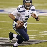 Seattle Seahawks quarterback Russell Wilson scrambles out of the pocket during the first half of the NFL Super Bowl XLVIII football game against the Denver Broncos Sunday, Feb. 2, 2014, in East Rutherford, N.J. (AP Photo/Kathy Willens)