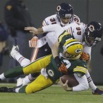 Green Bay Packers quarterback Aaron Rodgers is sacked by Chicago Bears' Shea McClellin (99) and Isaiah Frey (31) during the first half of an NFL football game Monday, Nov. 4, 2013, in Green Bay, Wis. (AP Photo/Jeffrey Phelps)