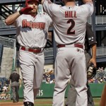 Arizona Diamondbacks' Jason Kubel, left, is greeted by Aaron Hill after driving him in with a two-run home run during the first inning of a baseball game against the Pittsburgh Pirates, Thursday, Aug. 9, 2012, in Pittsburgh. (AP Photo/Keith Srakocic)