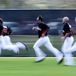 In this image taken with a slow shutter speed, Miami Marlins pitchers run drills during the team's first spring training baseball workout for pitchers and catchers Tuesday, Feb. 12, 2013, in Jupiter, Fla. (AP Photo/Julio Cortez)