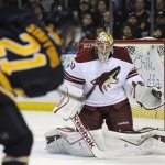  Buffalo Sabres right winger Drew Stafford (21) shoots the puck at Phoenix Coyotes goaltender Mike Smith (41) during the first period of an NHL hockey game in Buffalo, N.Y., Monday, Dec. 23, 2013. (AP Photo/Gary Wiepert)