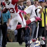 Arizona Cardinals running back William Powell, top, leaps over St. Louis Rams cornerback Bradley Fletcher after catching a pass during the second quarter of an NFL football game, Thursday, Oct. 4, 2012, in St. Louis. (AP Photo/Tom Gannam)