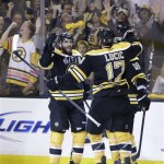 Boston Bruins center Patrice Bergeron, left, celebrates his goal against the Chicago Blackhawks with Milan Lucic (17) and Tyler Seguin (19) during the second period in Game 3 of the NHL hockey Stanley Cup Finals in Boston, Monday, June 17, 2013. (AP Photo/Elise Amendola)