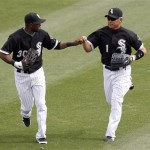 Chicago White Sox center fielder Alejandro de Anza, left, congratulates right fielder Kosuke Fukudome, right, of Japan, after Fukudome was able to throw out Los Angeles Dodgers' James Loney at home plate in the fifth inning of a spring training baseball game, Monday, March 5, 2012, in Glendale, Ariz. (AP Photo/Paul Connors)