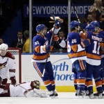 New York Islanders center Frans Nielsen (51), of Denmark, left wing Matt Moulson (26), defenseman Lubomir Visnovsky (11), of Slovakia, and center John Tavares (91) celebrate after Tavares scored in the first period of an NHL hockey game at Nassau Coliseum in Uniondale, N.Y., Tuesday, Oct. 8, 2013. (AP Photo/Kathy Willens)