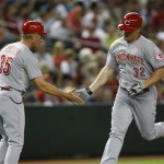 Cincinnati Reds Jay Bruce (32), right, celebrates with third base coach Chris Speier (35) in the fourth inning after hitting a solo home run against the Arizona Diamondbacks during a baseball game on Friday, June 21, 2013, in Phoenix. (AP Photo/Rick Scuteri)