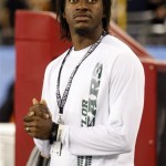 Washington Redskins quarterback Robert Griffin III watches Baylor and Central Florida play during the first half of the Fiesta Bowl NCAA college football game, Wednesday, Jan. 1, 2014, in Glendale, Ariz. (AP Photo/Rick Scuteri)