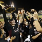 Arizona State pitcher Dallas Escobedo, center, holds the 2011 Division I National Championship trophy in the air after Arizona State defeated Florida 7-2 in a Women's College World Series championship series game in Oklahoma City, Tuesday, June 7, 2011. (AP Photo/Sue Ogrocki)