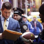  Former Denver Broncos quarterback Tim Tebow signs autographs for fans on Super Bowl Boulevard, Friday, Jan. 31, 2014, in New York's Times Square. The Seattle Seahawks are scheduled to play the Broncos in the NFL Super Bowl XLVIII football game on Sunday, Feb. 2, at MetLife Stadium in East Rutherford, N.J. (AP Photo/Mark Lennihan)