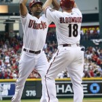 Arizona Diamondbacks' Chris Young high-fives Willie Bloomquist (18) after Young hit a two-run home run in the first inning of an opening day baseball game against the San Francisco Giants, Friday, April 6, 2012, in Phoenix. (AP Photo/Matt York)