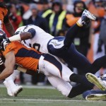 Denver Broncos wide receiver Eric Decker (87) is tackled by San Diego Chargers defensive back Darrell Stuckey (25) after catching a pass in the first quarter of an NFL AFC division playoff football game, Sunday, Jan. 12, 2014, in Denver. (AP Photo/Charlie Riedel)
