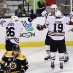 Chicago Blackhawks left wing Bryan Bickell, center, celebrates his goal with Chicago Blackhawks center Jonathan Toews (19) and Chicago Blackhawks center Michal Handzus (26), of Slovakia, during the third period in Game 6 of the NHL hockey Stanley Cup Finals against the Boston Bruins, Monday, June 24, 2013, in Boston. (AP Photo/Charles Krupa)