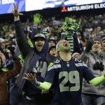  Seattle Seahawks fans celebrate a Seattle Seahawks touchdown run by Marshawn Lynch during the second half of the NFL football NFC Championship game against the San Francisco 49ers, Sunday, Jan. 19, 2014, in Seattle. (AP Photo/Elaine Thompson)