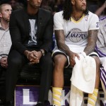  Los Angeles Lakers guard Kobe Bryant, left, and Jordan Hill sift on the bench during the first half of the Lakers' NBA basketball game against the Miami Heat in Los Angeles, Wednesday, Dec. 25, 2013. (AP Photo/Chris Carlson)