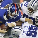 New York Giants quarterback Eli Manning (10) is taken down by New York Giants defensive tackle Cullen Jenkins (99) and defensive tackle Nick Hayden (96) during the second half of an NFL football game Sunday, Sept. 8, 2013, in Arlington, Texas. (AP Photo/LM Otero)
