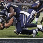 St. Louis Rams outside linebacker Alec Ogletree (52) stops Seattle Seahawks quarterback Russell Wilson (3) near the goal line during the first half of an NFL football game, Monday, Oct. 28, 2013, in St. Louis. (AP Photo/Tom Gannam)