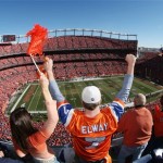  Denver Broncos fans raise their arms in support start of the AFC Championship NFL football playoff game as the Broncos host the New England Patriots in Sports Authority Field at Mile High Stadium on Sunday, Jan. 19, 2014, in Denver. (AP Photo/David Zalubowski)