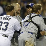 Los Angeles Dodgers' Jerry Hairston Jr. and a teammate, right, are restrained by A.J. Ellis and San Diego Padres' Yonder Alonso after a brawl that had subsided started up again during the sixth inning of baseball game in San Diego, Thursday, April 11, 2013. (AP Photo/Lenny Ignelzi)