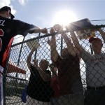 Atlanta Braves pitcher Craig Kimbrel (46) signs autographs for fans after a spring training baseball workout Tuesday, Feb. 12, 2013, in Kissimmee, Fla. (AP Photo/David J. Phillip)