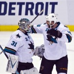 San Jose Sharks goalie Antti Niemi (31), of Finland, celebrates with captain Joe Thornton (19), Niemi blocked the game winning shootout shot after overtime in an NHL hockey game in Detroit, Mich., Monday, Oct. 21, 2013. San Jose won 1-0 on shootouts. (AP Photo/Tony Ding)