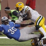 Detroit Lions running back Joique Bell (35) stretches for yardage as he is defended by Green Bay Packers strong safety Morgan Burnett (42) during the fourth quarter of an NFL football game at Ford Field in Detroit, Thursday, Nov. 28, 2013. (AP Photo/Duane Burleson)
