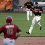  San Francisco Giants shortstop Brandon Hicks, right, makes the throw to first in time to get the out on Arizona Diamondbacks' Chris Owings, left, during the ninth inning of a spring exhibition baseball game on Sunday, March 2, 2014, in Scottsdale, Ariz. (AP Photo/Gregory Bull)