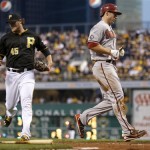 Arizona Diamondbacks' Paul Goldschmidt, right, scores from third past Pittsburgh Pirates starting pitcher Gerrit Cole (45) on a hit by Martin Prado in the fourth inning of a baseball game on Friday, Aug. 16, 2013, in Pittsburgh. (AP Photo/Keith Srakocic)