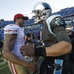 San Francisco 49ers quarterback Colin Kaepernick, left, greets Carolina Panthers quarterback Cam Newton after the second half of a divisional playoff NFL football game, Sunday, Jan. 12, 2014, in Charlotte, N.C. The San Francisco 49ers won 23-10. (AP Photo/Gerry Broome)