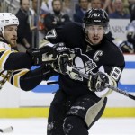 Pittsburgh Penguins' Sidney Crosby (87) gets a pass off in front of Boston Bruins' Andrew Ference during the second period of Game 2 of the NHL hockey Stanley Cup playoffs Eastern Conference finals, in Pittsburgh on Monday, June 3, 2013. (AP Photo/Gene J. Puskar)