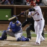 St. Louis Cardinals' Yadier Molina hits an RBI single during the third inning of Game 6 of the National League baseball championship series against the Los Angeles Dodgers, Friday, Oct. 18, 2013, in St. Louis. (AP Photo/Chris Carlson)