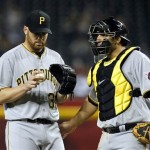 Pittsburgh Pirates' Chris Resop, left, talks with Rod Barajas during the eighth inning of a baseball game against the Arizona Diamondbacks Monday, April 16, 2012, in Phoenix. The Diamondbacks defeated the Pirates 5-1.(AP Photo/Ross D. Franklin)