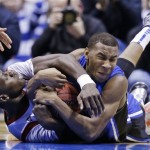 Louisville center Gorgui Dieng, left, and Duke guard Rasheed Sulaimon battle for a loose ball during the second half of the Midwest Regional final in the NCAA college basketball tournament, Sunday, March 31, 2013, in Indianapolis. Louisville won 85-63 to advance to the Final Four. (AP Photo/Darron Cummings)