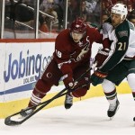 Phoenix Coyotes' Shane Doan (19) and Minnesota Wild's Kyle Brodziak (21) battle for the puck during the first period in an NHL hockey game, Thursday, Feb. 28, 2013, in Glendale, Ariz. (AP Photo/Ross D. Franklin)