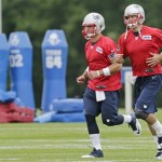 New England Patriots quarterbacks Tim Tebow and Tom Brady, right, run during a team football practice in Foxborough, Mass., Tuesday June 11, 2013. (AP Photo/Charles Krupa)