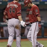 Arizona Diamondbacks' Eric Chavez, right, shakes hands with teammate Paul Goldschmidt (44) after they scored on a third-inning two-run home run by Chavez off Tampa Bay Rays starting pitcher Jeremy Hellickson during an interleague baseball game on Wednesday, July 31, 2013, in St. Petersburg, Fla. (AP Photo/Chris O'Meara)