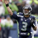 Seattle Seahawks quarterback Russell Wilson passes against the New Orleans Saints during the first quarter of an NFC divisional playoff NFL football game in Seattle, Saturday, Jan. 11, 2014. (AP Photo/Elaine Thompson)