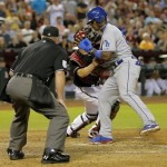 Arizona Diamondbacks catcher Miguel Montero tags out Los Angeles Dodgers' Yasiel Puig as umpire Marvin Hudson looks on during the fifth inning of a baseball game, Tuesday, July 9, 2013, in Phoenix. (AP Photo/Matt York)