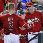 Arizona Diamondbacks' Aaron Hill (2) is greeted 
in the dugout by manager Kirk Gibson after 
hitting a home run during the first inning of 
an interleague baseball game against the 
Seattle Mariners, Wednesday, June 20, 2012, in 
Phoenix. (AP Photo/Matt York)