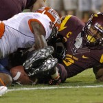 Illinois defensive back Patrick Nixon-Youman (4) dives on Arizona State running back Cameron Marshall (6) as Marshall fumbles near the goal line during the first half of an NCAA college football game, Saturday, Sept. 8, 2012, in Tempe, Ariz. (AP Photo/Matt York)
