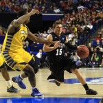 Butler guard Rotnei Clarke (15) drives against Marquette center Chris Otule (42) in the first half of a third-round NCAA college basketball tournament game on Saturday, March 23, 2013, in Lexington, Ky. (AP Photo/James Crisp)
