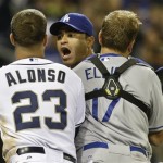 Los Angeles Dodgers' Jerry Hairston Jr. is restrained by A.J. Ellis and San Diego Padres' Yonder Alonso after a brawl that had subsided started up again during the sixth inning of baseball game in San Diego, Thursday, April 11, 2013. (AP Photo/Lenny Ignelzi)
