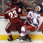 New York Rangers right wing Ryan Callahan (24) is checked along the boards by Phoenix Coyotes defenseman Oliver Ekman-Larsson (23), of Sweden, in the third period of an NHL hockey game on Saturday, Dec. 17, 2011, in Glendale, Ariz. The Rangers won 3-2. (AP Photo/Paul Connors)